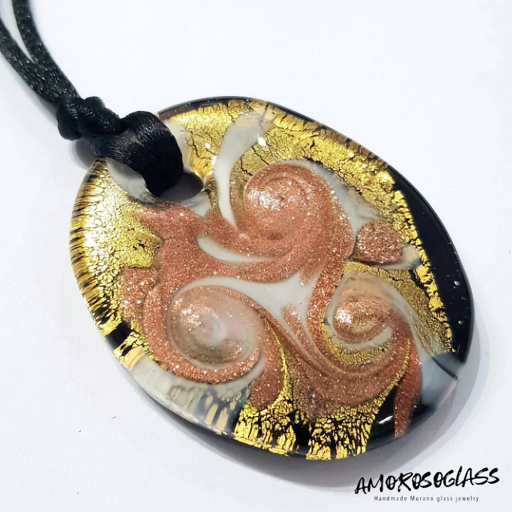 Pendente ovale in vetro di Murano lavorato a lume con foglia Oro 24kt, vortici di avventurina e venature bianco latte, fondo nero.