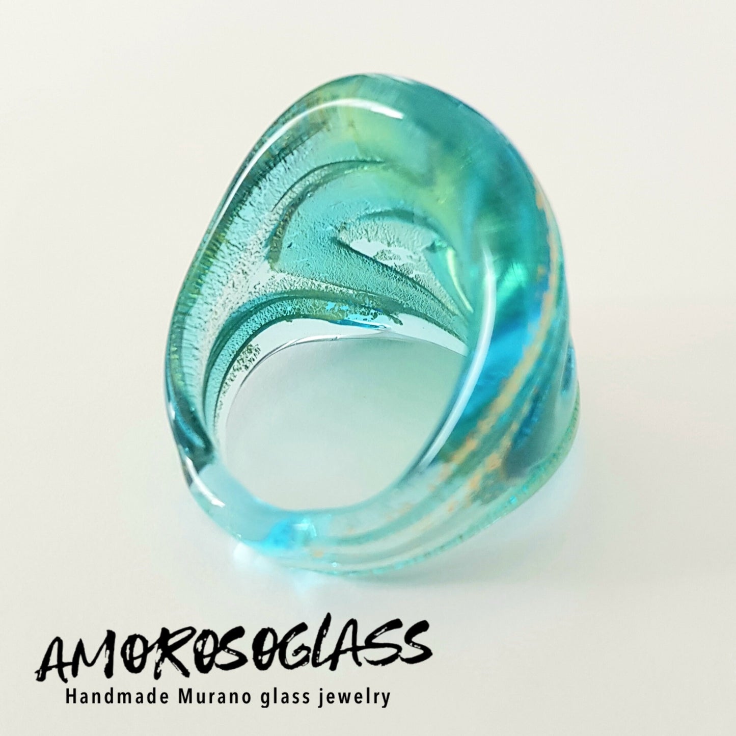 Anello VORTICE a fascia, base acquamare trasparente con foglia oro24kt e vortice acquamare trasparente,in vetro di Murano lavorato a lume.