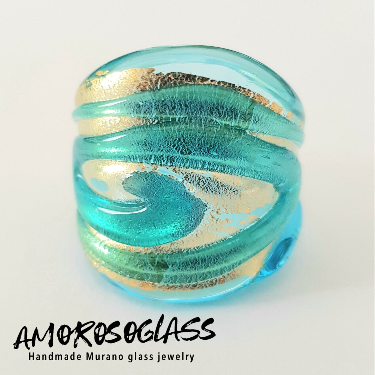 Anello VORTICE a fascia, base acquamare trasparente con foglia oro24kt e vortice acquamare trasparente,in vetro di Murano lavorato a lume.